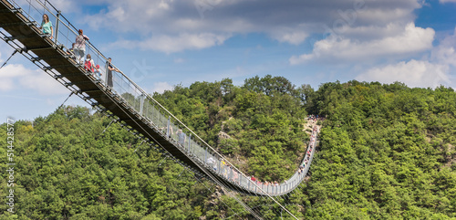 Panorama of tourists crossing the suspension bridge in Geierlay photo