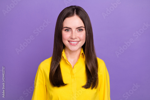 Portrait of attractive cheerful brunette girl wearing bright shirt isolated over vivid violet purple color background