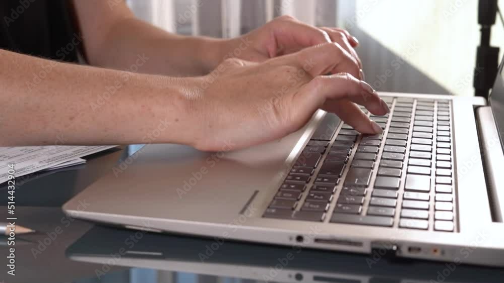 Female hands of business woman professional user worker using typing on laptop notebook keyboard sit at home office desk working online. close up side view Female hands of business woman professional user worker using typing on laptop notebook keyboard sit at home office desk working online. close up side view