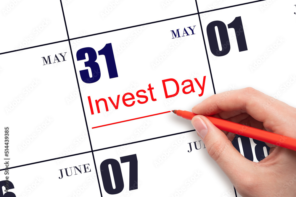 Hand drawing red line and writing the text Invest Day on calendar date May 31. Business and financial concept. Hand drawing red line and writing the text Invest Day on calendar date May 31. Business and financial concept.