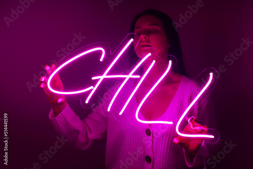 Beautiful girl with neon signs. Pink neon sign chill. Trendy style. Neon sign. Custom neon. Home decor.