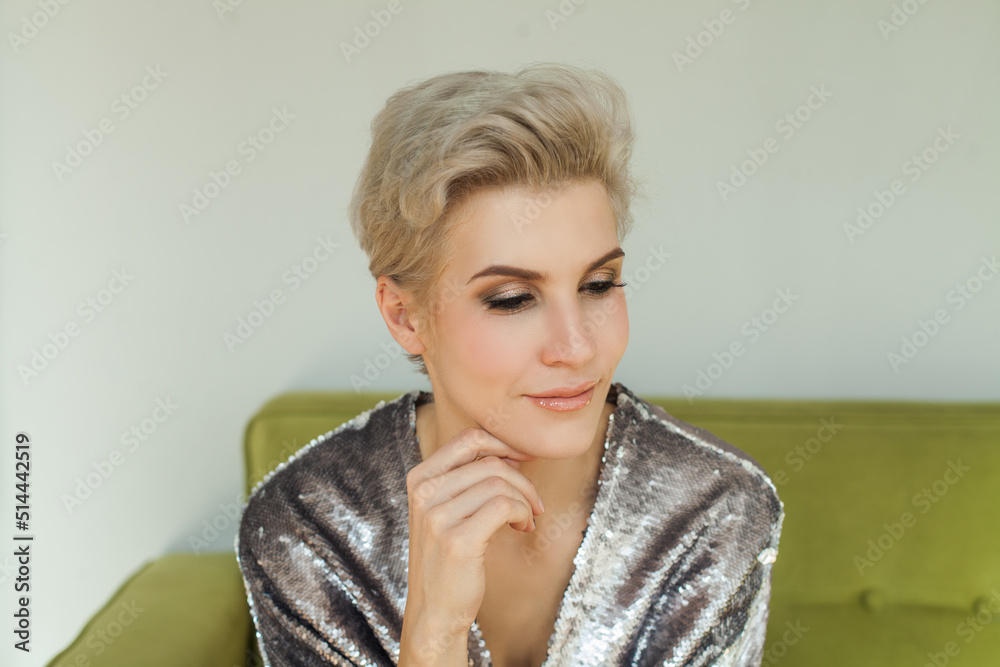 Close up image of cute blonde woman with short pixie hairstyle at home Close up image of cute blonde woman with short pixie hairstyle at home