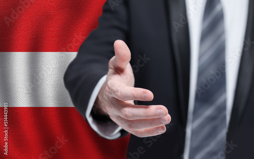 Welcome to the Austria. Hand on Austrian flag background. Business, politics, cooperation and travel concept