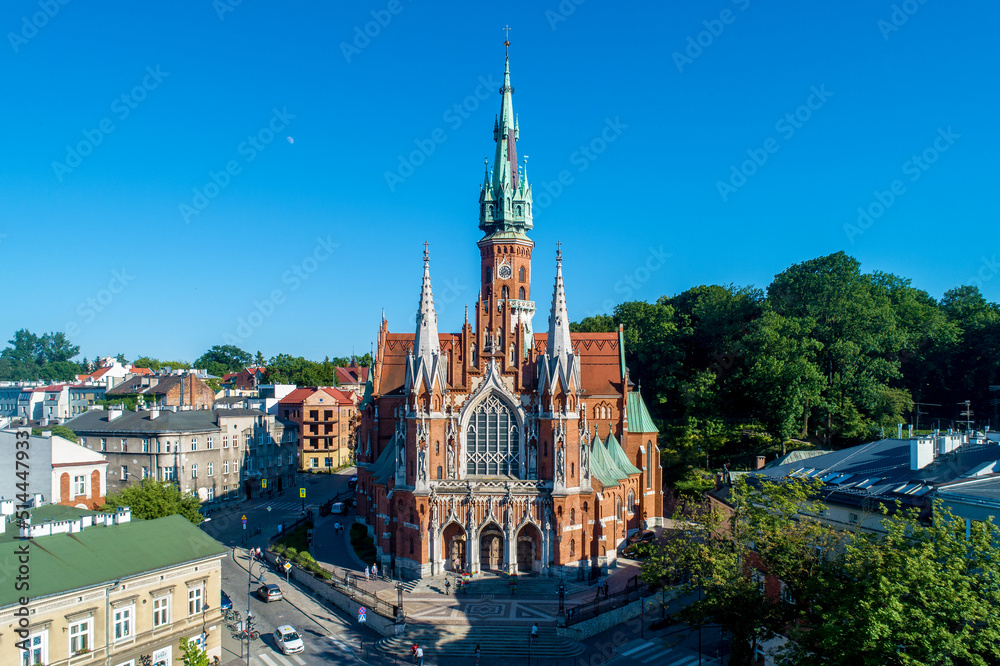 Krakow, Poland. Church Saint Joseph - a historic Roman Catholic church in Gothic Revival (neo-Gothic) style at the Podgorski Square in Podgorze district in Cracow in sunset light. Aerial view.