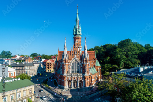 Krakow, Poland. Church Saint Joseph - a historic Roman Catholic church in Gothic Revival (neo-Gothic) style at the Podgorski Square in Podgorze district in Cracow in sunset light. Aerial view.