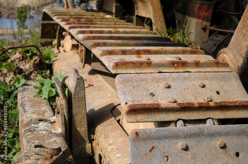 Chain drive of an old rusted bulldozer that was parked outdoors