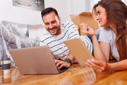 Couple searching for home redecoration ideas while moving in together photo