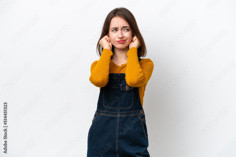 Young Ukrainian woman isolated on white background frustrated and covering ears