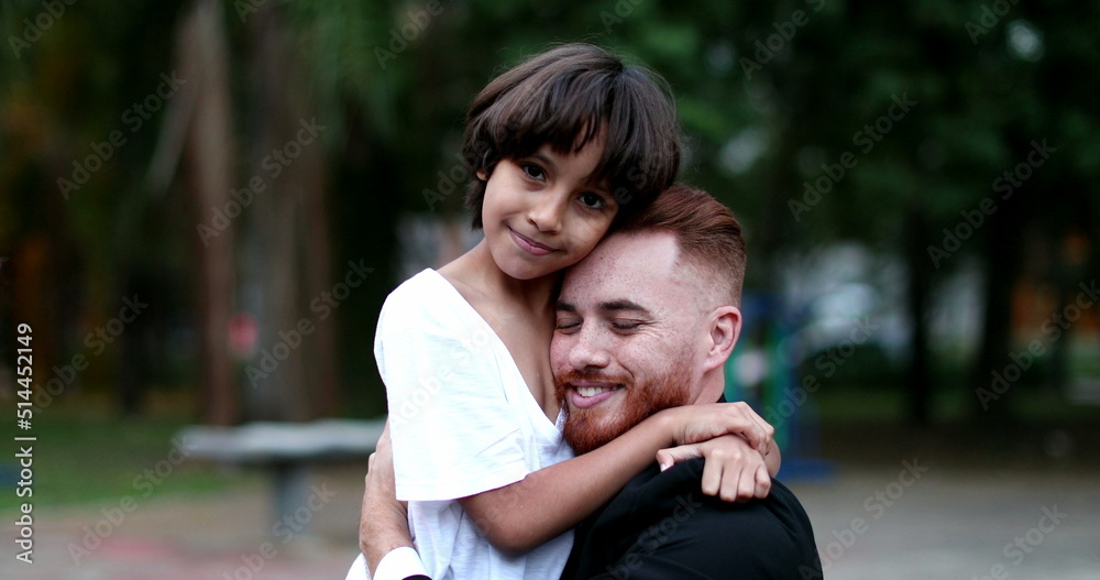 Caring loving moment of son kissing father cheek. Ethnically diverse family parent and child love and care Caring loving moment of son kissing father cheek. Ethnically diverse family parent and child love and care