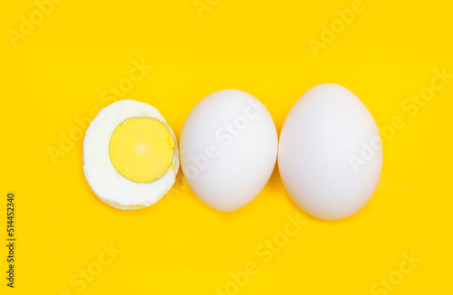 whole eggs and boil egg isolated on yellow background,top view