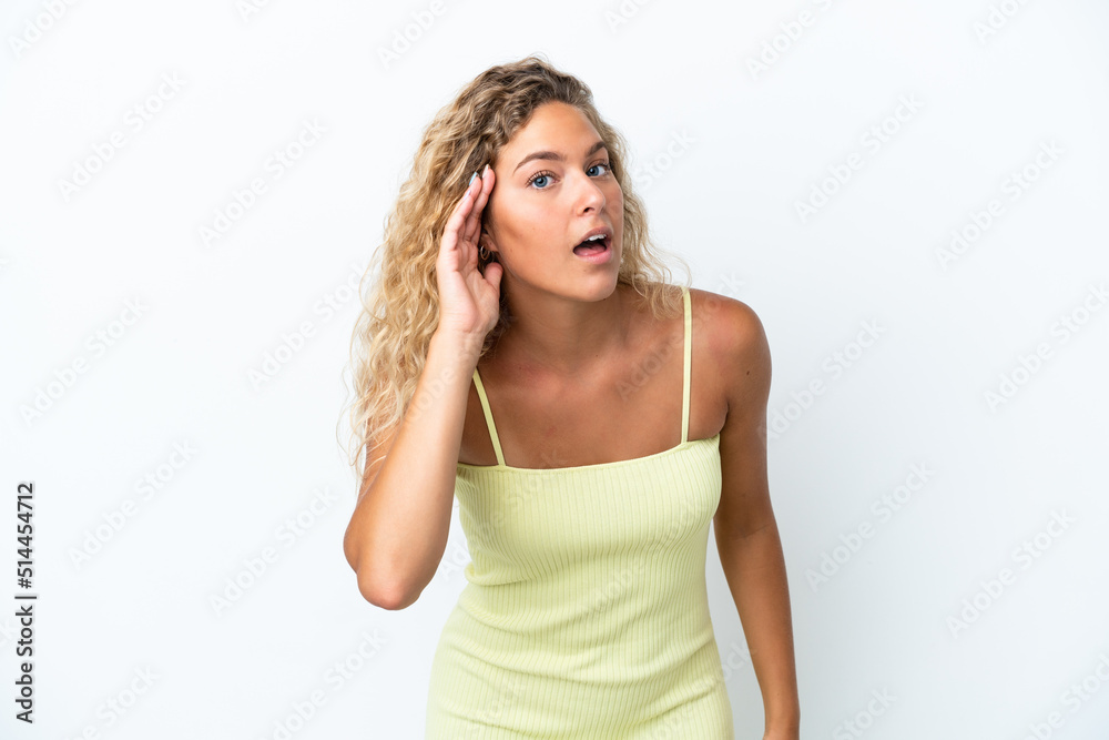 Girl with curly hair isolated on white background listening to something by putting hand on the ear Girl with curly hair isolated on white background listening to something by putting hand on the ear
