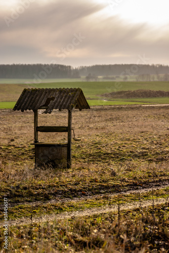 Old abandoned well in the autumn field