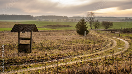 Old abandoned well in the autumn field