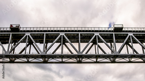 Train bridge over the river and cloudy sky