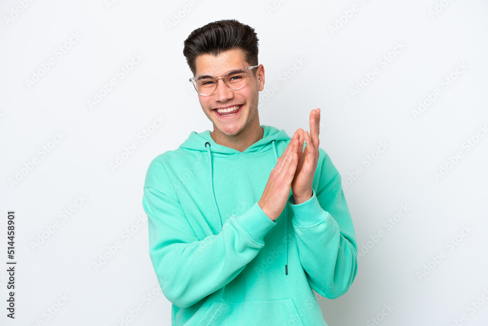 Young handsome caucasian man isolated on white bakcground applauding after presentation in a conference Young handsome caucasian man isolated on white bakcground applauding after presentation in a conference