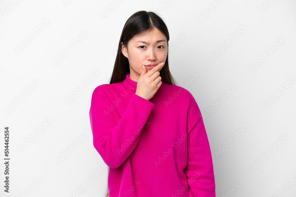 Young Chinese woman isolated on white background having doubts Young Chinese woman isolated on white background having doubts