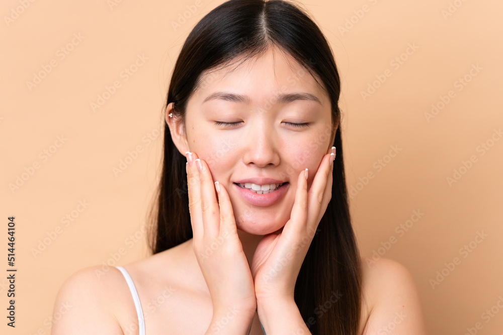 Young Chinese woman isolated on beige background . Portrait Young Chinese woman isolated on beige background . Portrait