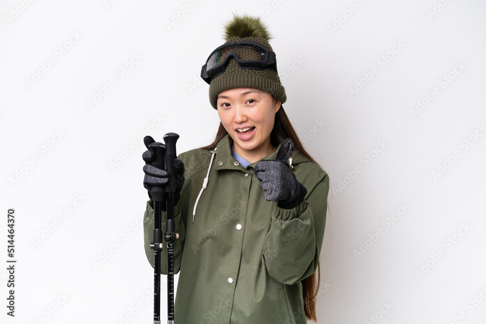 Young Chinese woman wearing winter jacket isolated on white background with thumbs up because something good has happened Young Chinese woman wearing winter jacket isolated on white background with thumbs up because something good has happened