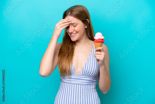 Young caucasian woman in swimsuit eating ice cream isolated on blue background has realized something and intending the solution