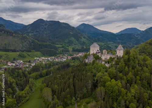 Aerial drone view of castle Gallenstein, close to Sankt Gallen in Austria on a cloudy summer day. Green forest surrounding the ruins of a castle.