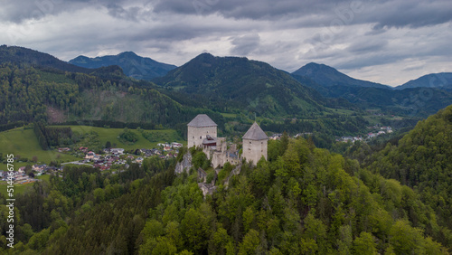 Aerial drone view of castle Gallenstein  close to Sankt Gallen in Austria on a cloudy summer day. Green forest surrounding the ruins of a castle.