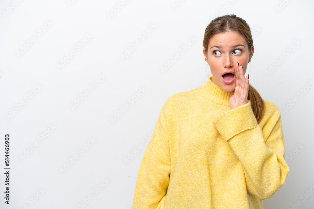 Young caucasian woman isolated on white background whispering something with surprise gesture while looking to the side Young caucasian woman isolated on white background whispering something with surprise gesture while looking to the side