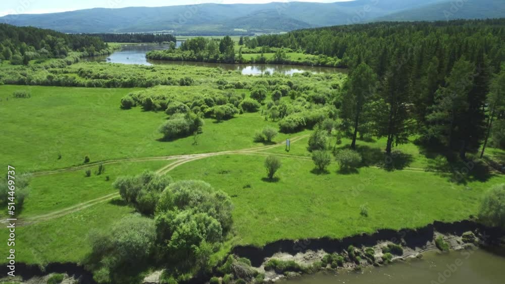 Aerial view of the river flowing in a green valley. The beauty of the summer natural landscape Aerial view of the river flowing in a green valley. The beauty of the summer natural landscape