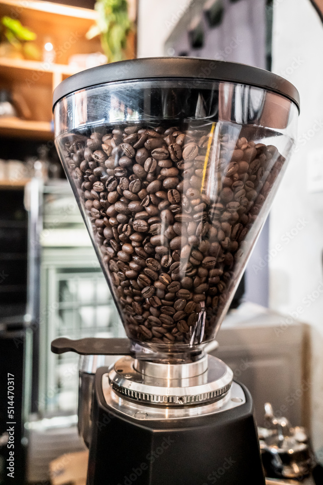 Fresh Dark Brown Coffee Beans in a Coffee Grinder at a Coffee Shop