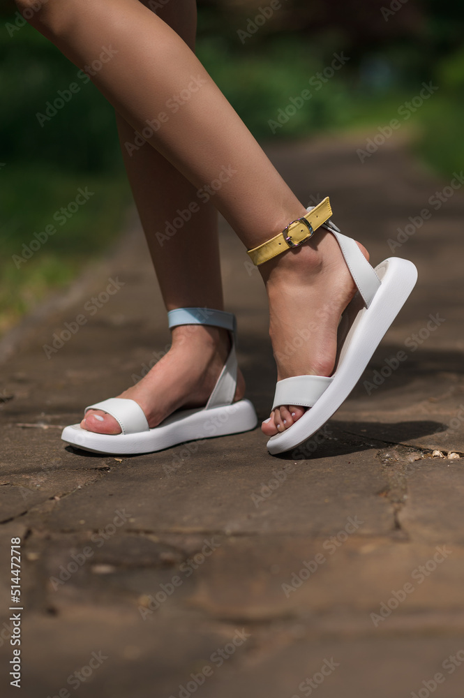 Summer comfortable collection of patriotic women's shoes. Ukrainian flag. White sandals