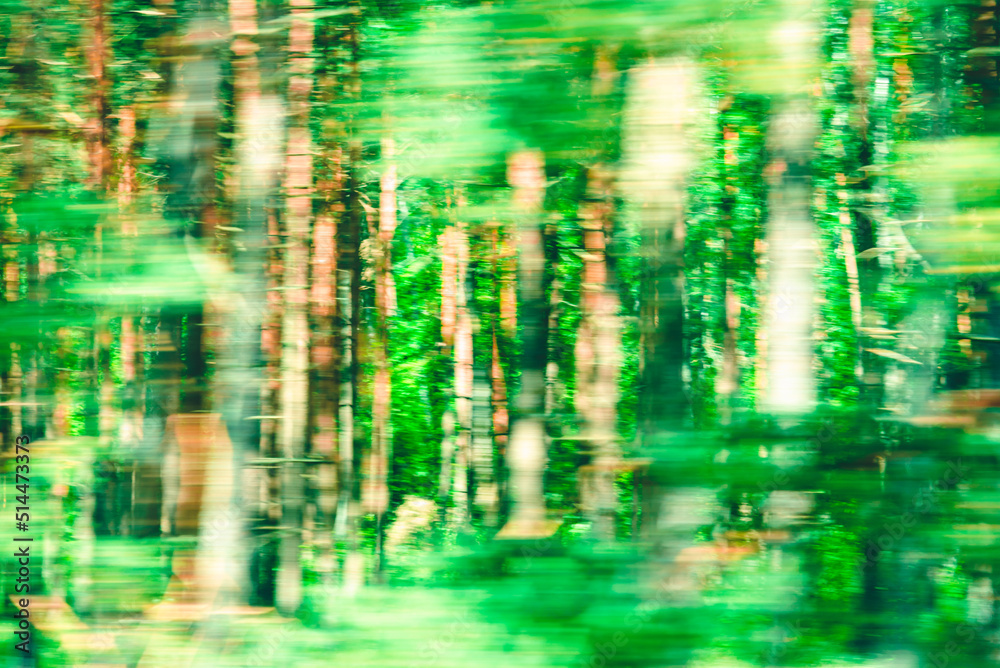 Abstract Green trees motion blurred green leaves background.