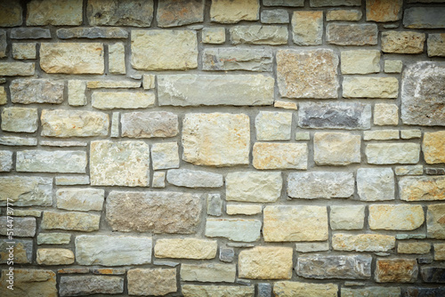 Solid yellow and beige stone wall with vignette  good for background