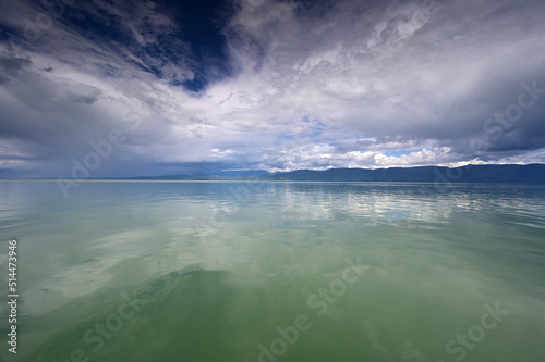 Beautiful dramatic summer cloudscape over Flathead Lake in Montana on calm June day. © Francisco
