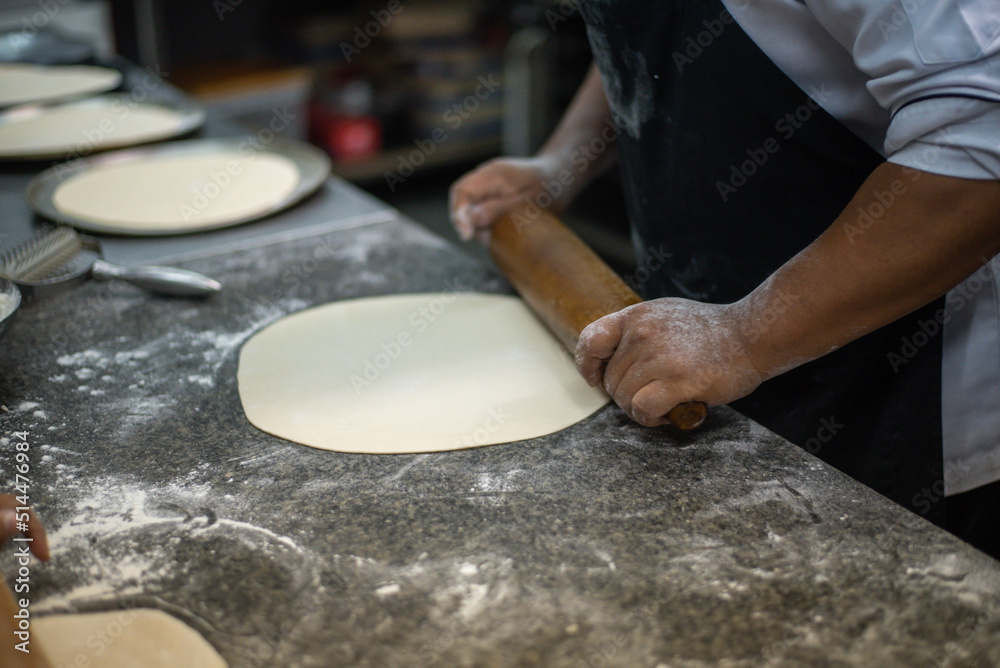 home bakery. Confectioner rolling gingerbread dough with rolling pin.People cooking food home bakery. Confectioner rolling gingerbread dough with rolling pin.People cooking food