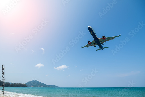 Plane is landing over sea with beach in phuket