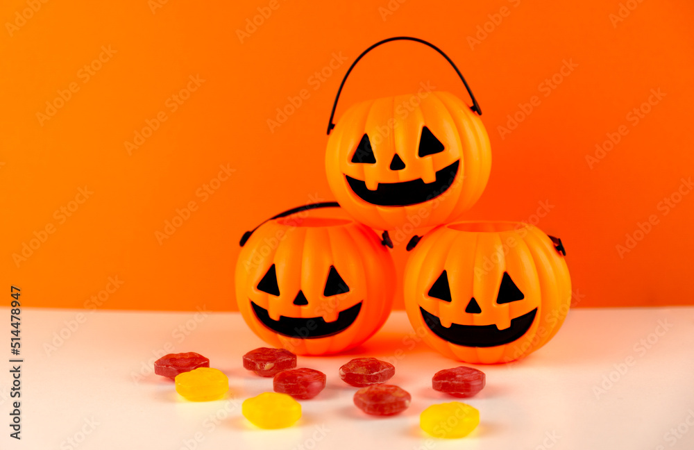 Fototapeta premium Three halloween pumpkins with candies