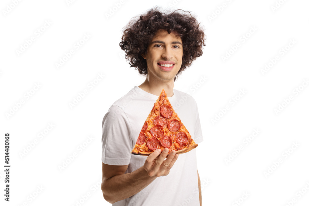 Cheerful young man holding a slice of pepperoni pizza and looking at camera Cheerful young man holding a slice of pepperoni pizza and looking at camera