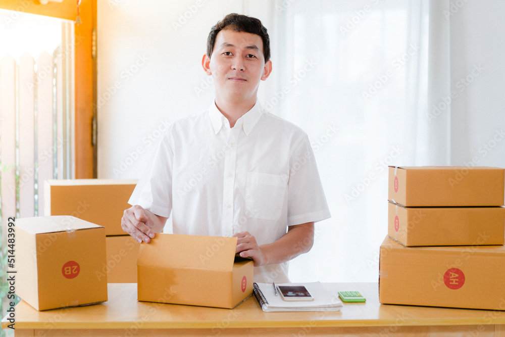person with boxes, Portrait of Asian man packing box and check list in the office business , SME internet work from home business .