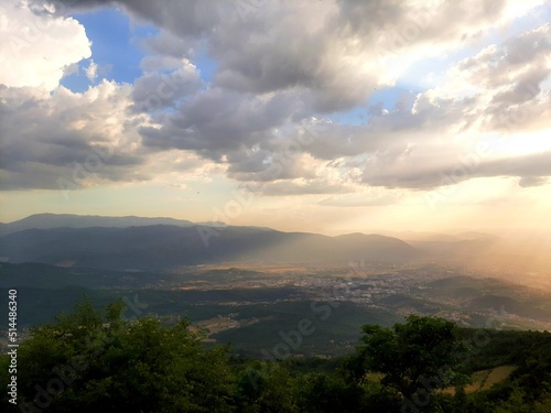 Sunset over the Sarajevo valley and mountains around, sun rays breaking through clouds, Bosnia and Herzegovina