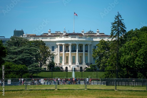 The White House showing the oval office of the president of the United States with tourists looking on a bright summer day.