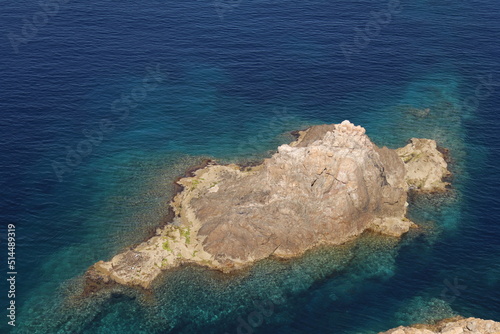 An island set against a rich blue sea shot from above, Corsica, France