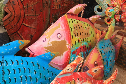 A display of metal fish all in bright vibrant colours, Corsica, France