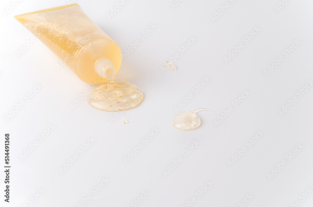 Cosmetics face care gel with gold additives on a white background