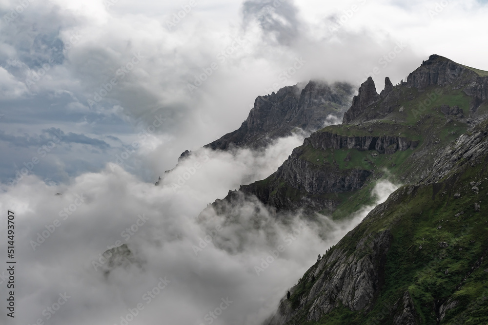 A stunning capture of the alpine peaks in clouds and fog  in the italian dolomites