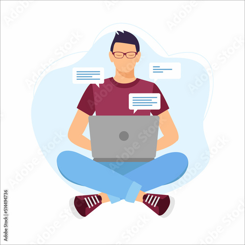 Guy sitting on the floor on the carpet with a laptop. Man sitting cross-legged and working on laptop.
