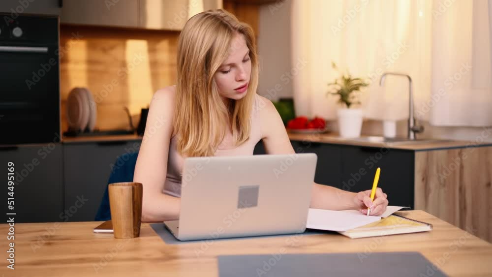 Student distance learning at home. Online education of smart young girl using laptop at home kitchen. Student distance learning at home. Online education of smart young girl using laptop at home kitchen.