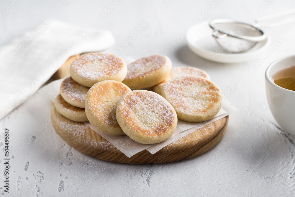 Wooden board with simple delicious homemade cookies baked in a pan on a light background Wooden board with simple delicious homemade cookies baked in a pan on a light background
