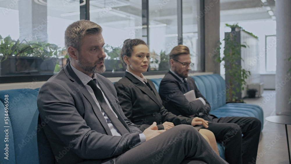 Nervous job applicants waiting for interview at company hr office, employment Nervous job applicants waiting for interview at company hr office, employment