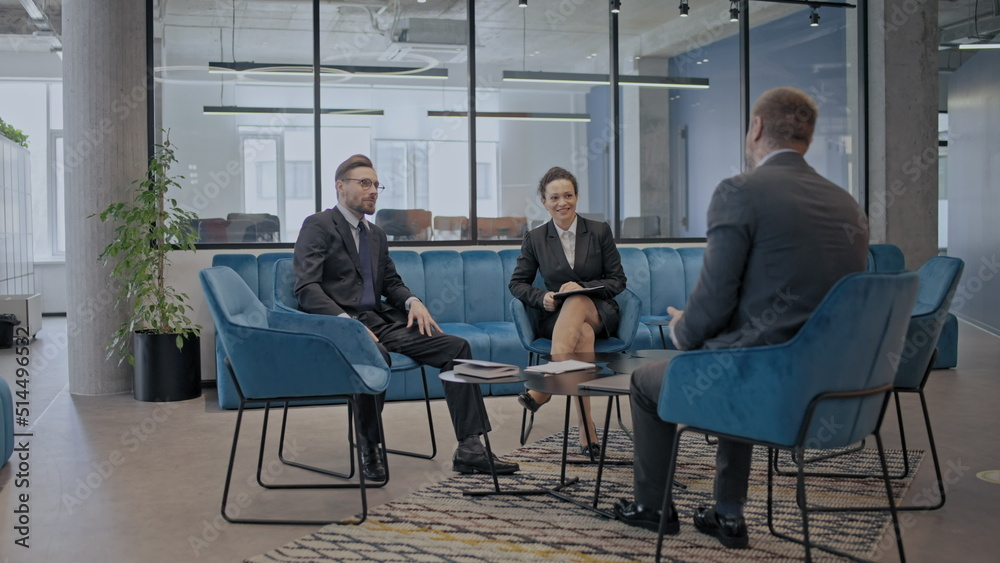 Male and female company employees talking, team discussing business project