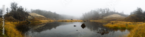 Panoramic view of a stagnant lagoon with a lot of fog in the forest. dramatic concept. Beaver damage to the environment. Endemic species Ushuaia, Argentina
