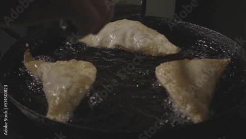 slow motion frying pies in hot oil and serving on a plate